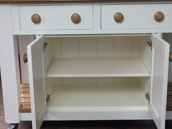 freestanding kitchen island with a double storage cupboard with a single adjustable shelf