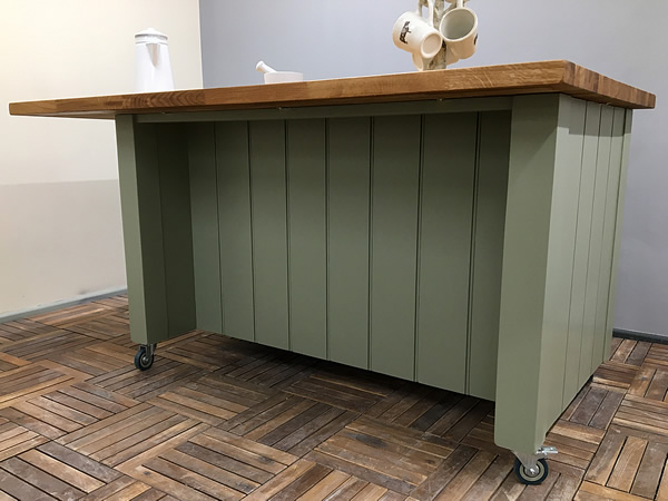 large freestanding kitchen island with a rear recess built-in for seating and storage of stools