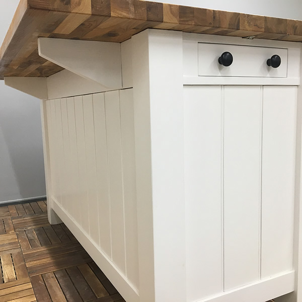 freestanding kitchen island incorporating a long breakfast bar